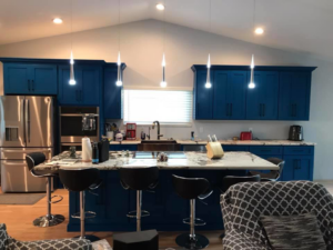 A modern kitchen remodel with blue cabinets and a large island by Celano Construction in Mesa, AZ