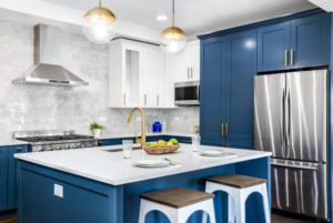 A modern kitchen remodel featuring blue and white cabinets and a large island by North Shore Kitchens in Pittsburgh, PA.