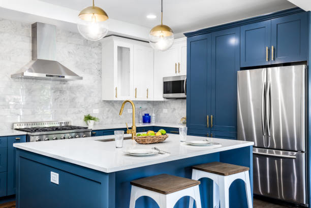 A modern kitchen remodel featuring blue and white cabinets and a large island by North Shore Kitchens in Pittsburgh, PA.