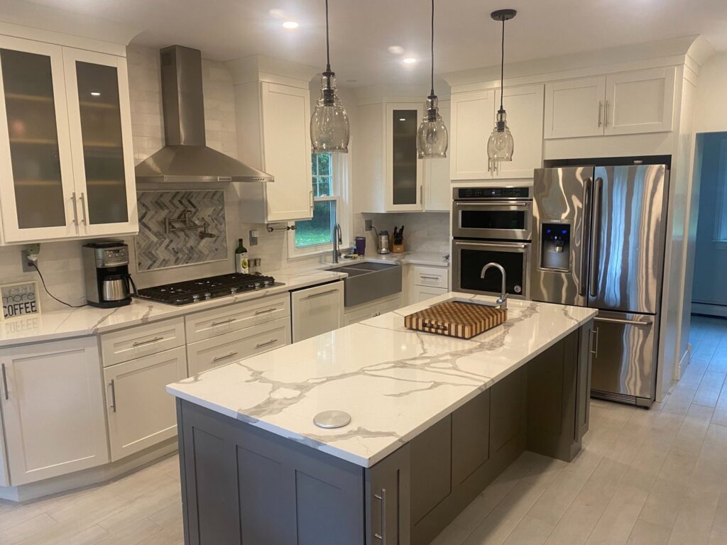 Completed modern kitchen remodel with new cabinets, island, and stainless steel appliances by CWS Handyman LLC in Seekonk, MA