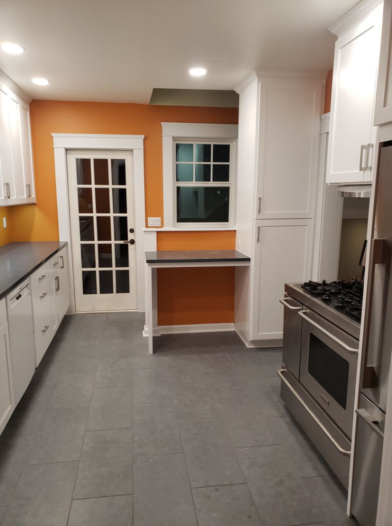 Modern kitchen remodel featuring new cabinets and tile flooring by Girard Builders in Medford, OR.