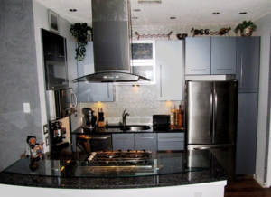Modern kitchen remodel with stainless steel appliances and dark countertops by Coastal Contracting Services Inc., Virginia Beach, VA.