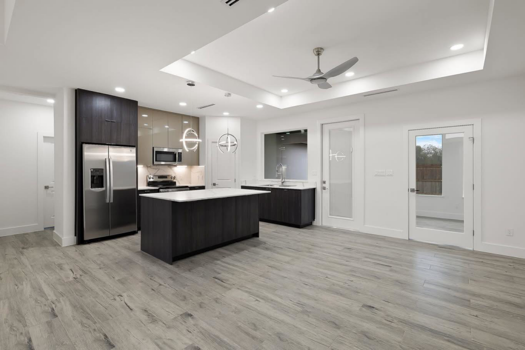 A beautifully finished modern kitchen remodel with dark cabinetry and an island by Wise Construction Group in Atlanta, GA.