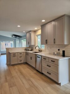 A modern kitchen remodel featuring light gray cabinets, white subway tile backsplash, and new flooring by Boisen Remodeling LLC in Appleton, WI.