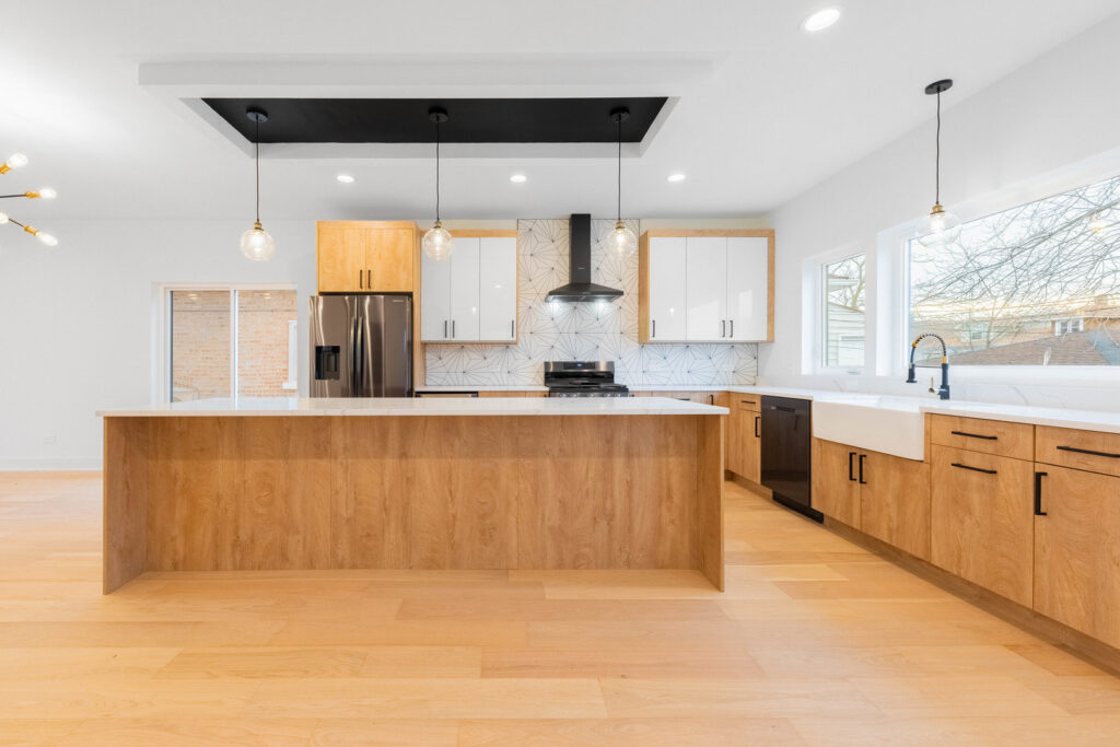 A spacious modern kitchen remodel featuring light wood and white cabinets by Inland Home Remodeling Inc. in Chicago, IL.