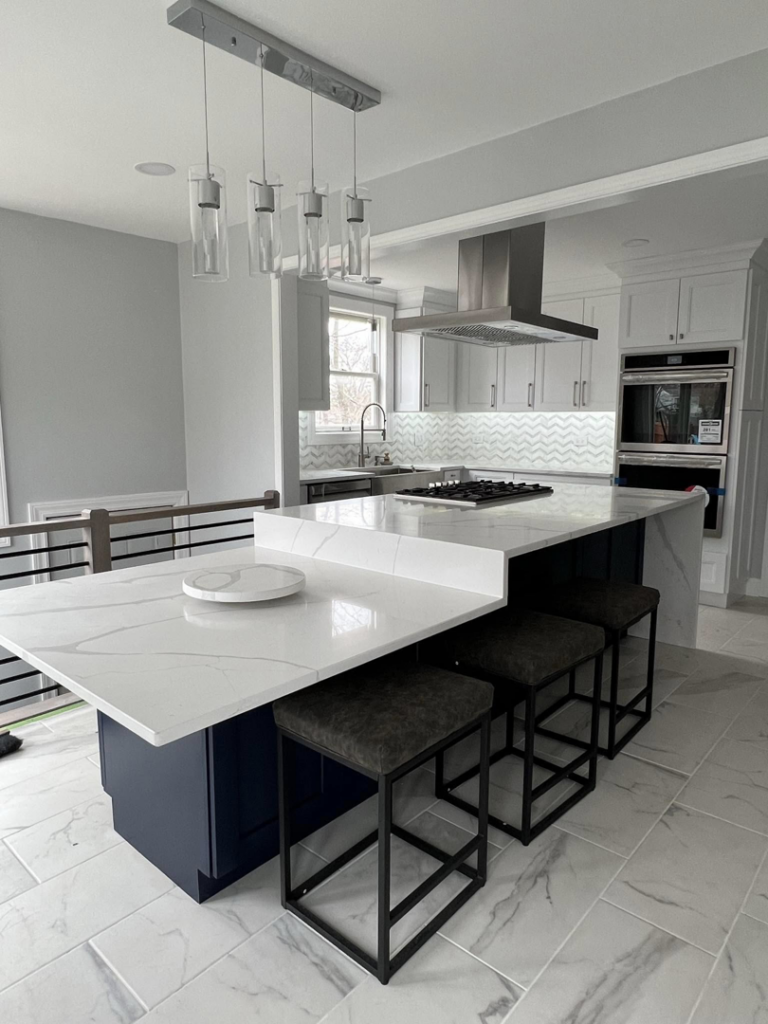 A modern kitchen remodel featuring a large island with seating, new appliances, and stylish lighting by Villegas Remodeling & Handyman in Chicago, IL.