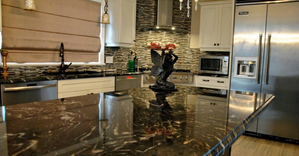 A modern kitchen remodel featuring dark granite countertops, white cabinets, and a tiled backsplash by JC Remodeling Ro LLC in Cleveland, OH.
