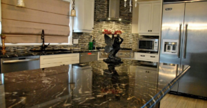 A modern kitchen remodel featuring dark granite countertops, white cabinets, and a tiled backsplash by JC Remodeling Ro LLC in Cleveland, OH.