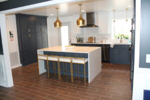 Stylish modern kitchen remodel with dark blue cabinets and a large island by KC's Improvement & Construction Co., Inc. in Greensboro, NC