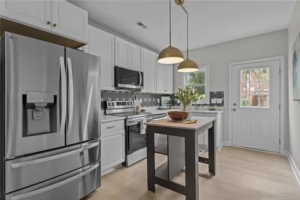 A newly remodeled modern kitchen with stainless steel appliances and white cabinets by Staley Contracting in Richmond, VA