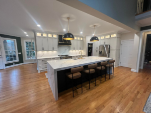 A spacious modern kitchen remodel with a large island and new cabinets by Rochester Contracting in Holly Springs, NC.