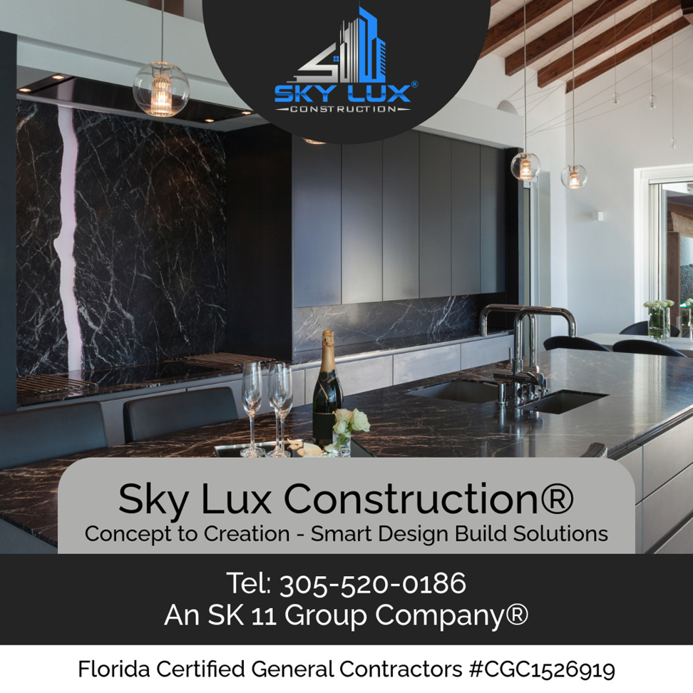 A modern kitchen remodel featuring dark cabinets and a marble island by SK 11 Group, Inc. in Miami, FL.