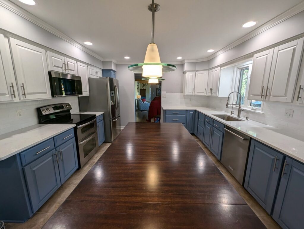 Modern kitchen remodel featuring two-tone cabinets and new appliances by Roche Painting in Allentown, PA.