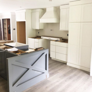 A modern kitchen remodel featuring new white cabinets and a stylish island by CopperRock in Nashville, TN.