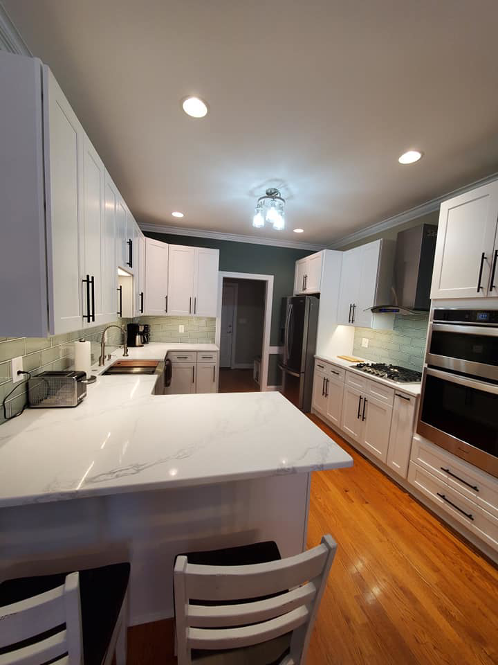 A modern kitchen remodel featuring white cabinets and new countertops by D and R Professional Home Services in Services Available In.