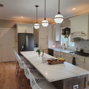 A modern kitchen remodel featuring white cabinets, a large island, and pendant lighting by Mainville Construction & Remodeling LLC in Newington, CT.