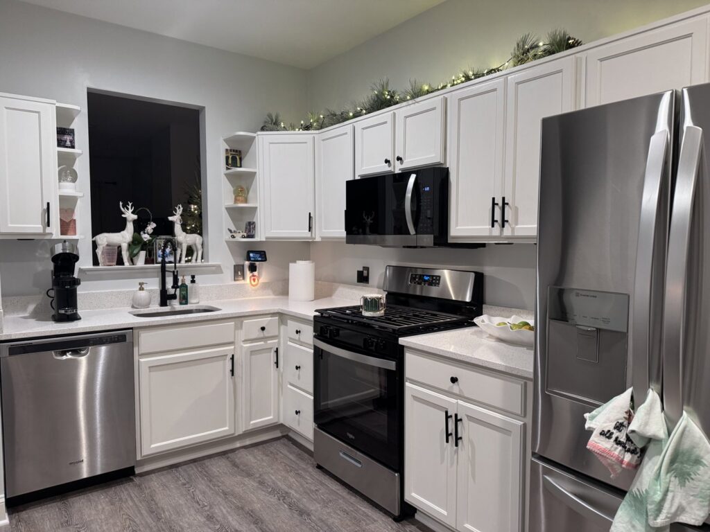 A modern kitchen remodel featuring white cabinets and stainless steel appliances by M J Services Home Remodeling in Gaithersburg, MD.