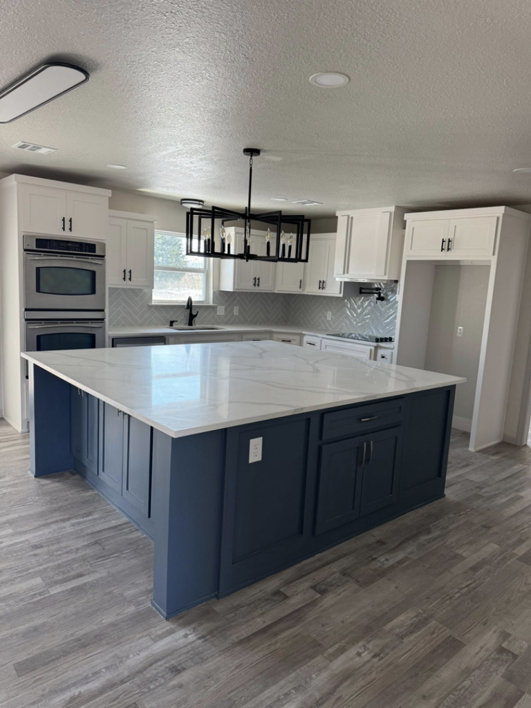 A modern kitchen remodel featuring a large island and new cabinetry by Castillo Contracting & Remodeling in Broken Arrow, OK.