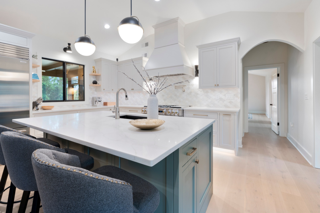 A modern kitchen remodel featuring a large island, pendant lighting, and new cabinetry by KACE Construction in Nashville, TN.
