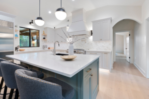 A modern kitchen remodel featuring a large island, pendant lighting, and new cabinetry by KACE Construction in Nashville, TN.