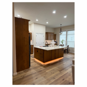 A modern kitchen remodel with island and under-cabinet lighting completed by Tom Broglia Building & Remodeling Services in Boise, ID.