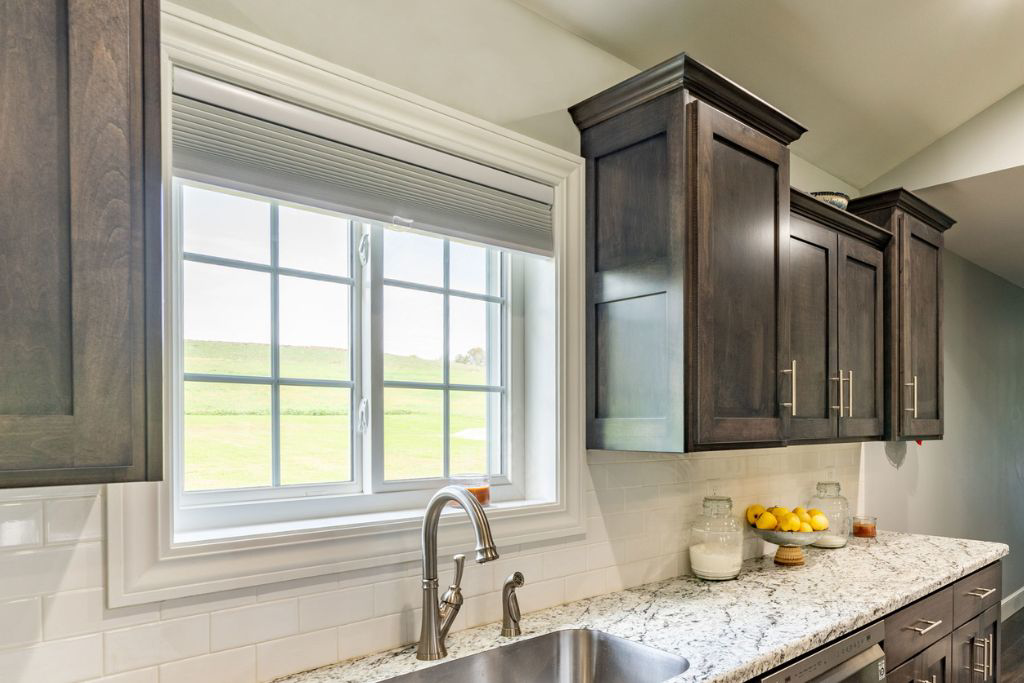 A modern kitchen renovation featuring dark cabinets and granite countertops by Smucker & Sons Inc in Ephrata, PA.
