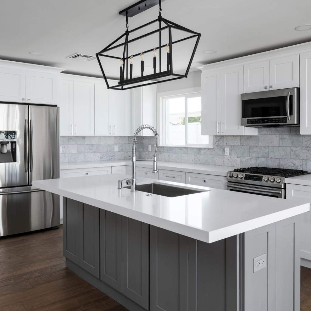 A modern kitchen renovation featuring white cabinets and a grey island completed by Green Building Partners Inc. in Chicago, IL.
