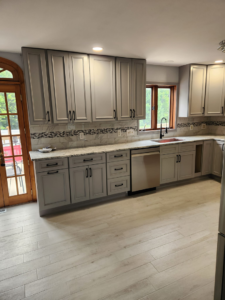 A modern kitchen renovation featuring new grey cabinets and stainless steel appliances by Zig's Home Improvements in Reading, PA.
