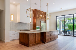 A beautifully renovated modern kitchen with a large island and wooden cabinetry by Ignite Construction in Tempe, AZ.