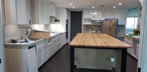 A modern kitchen renovation in progress with new cabinets and island by Gourley Contractors, LLC, Corpus Christi, TX.