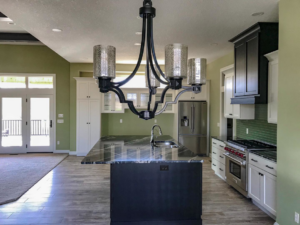A modern kitchen renovation featuring a large island, new cabinets, and appliances by Grabill Painting and Drywall in Fort Wayne, IN.