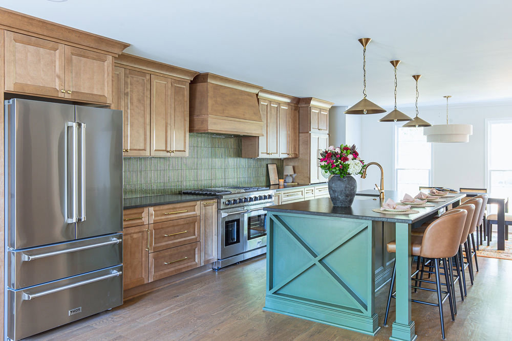 Modern kitchen renovation with light wood cabinets, green backsplash, and a large island by HomePro Improvements, Roswell, GA.