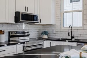 A modern kitchen renovation featuring new cabinets and appliances by Orival Property Services in Boston, MA.