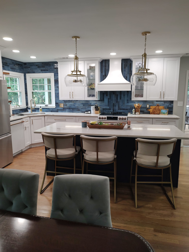 A beautifully renovated modern kitchen with blue tile backsplash and white cabinets by Rapid Response Crew in Charlotte, NC.