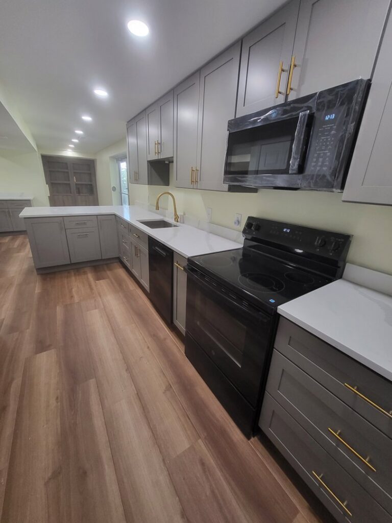 A modern kitchen renovation featuring new appliances and cabinetry by Top Gunn Family Construction in Truxton, MO.
