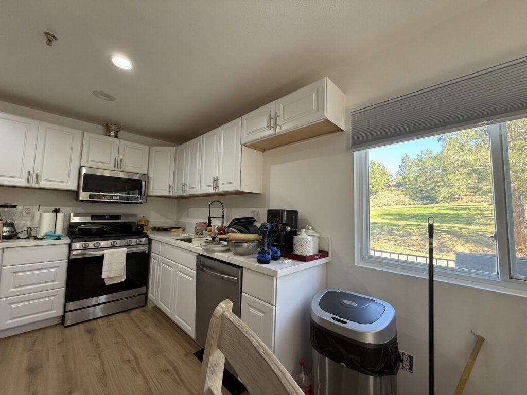 A modern kitchen renovation featuring white cabinets and stainless steel appliances by Sal Handyman Services in Canyon Country, CA