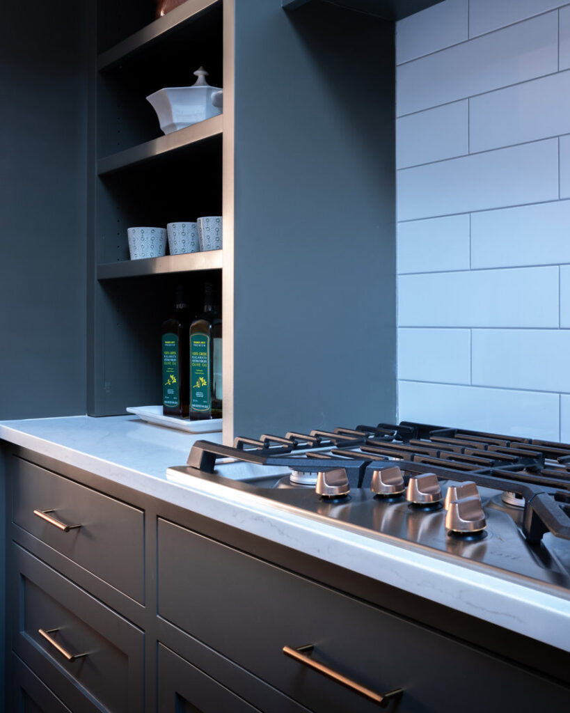 Modern kitchen stovetop with dark cabinets and white subway tile backsplash, installed by Home Made Easy in Norwalk, CT.