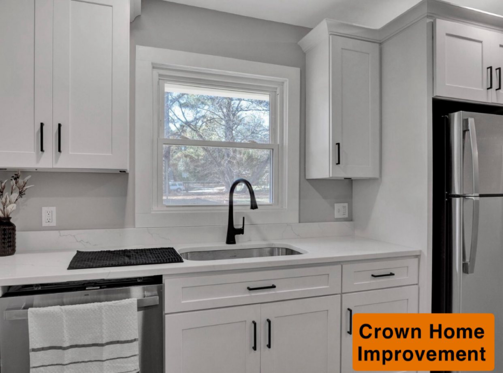 A modern kitchen featuring white cabinets, quartz countertops, and a new sink and dishwasher installed by Crown Home Improvements in Charlotte, NC