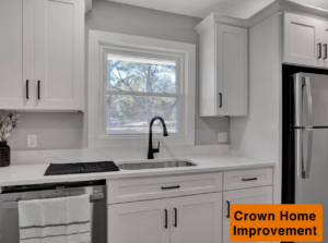 A modern kitchen featuring white cabinets, quartz countertops, and a new sink and dishwasher installed by Crown Home Improvements in Charlotte, NC