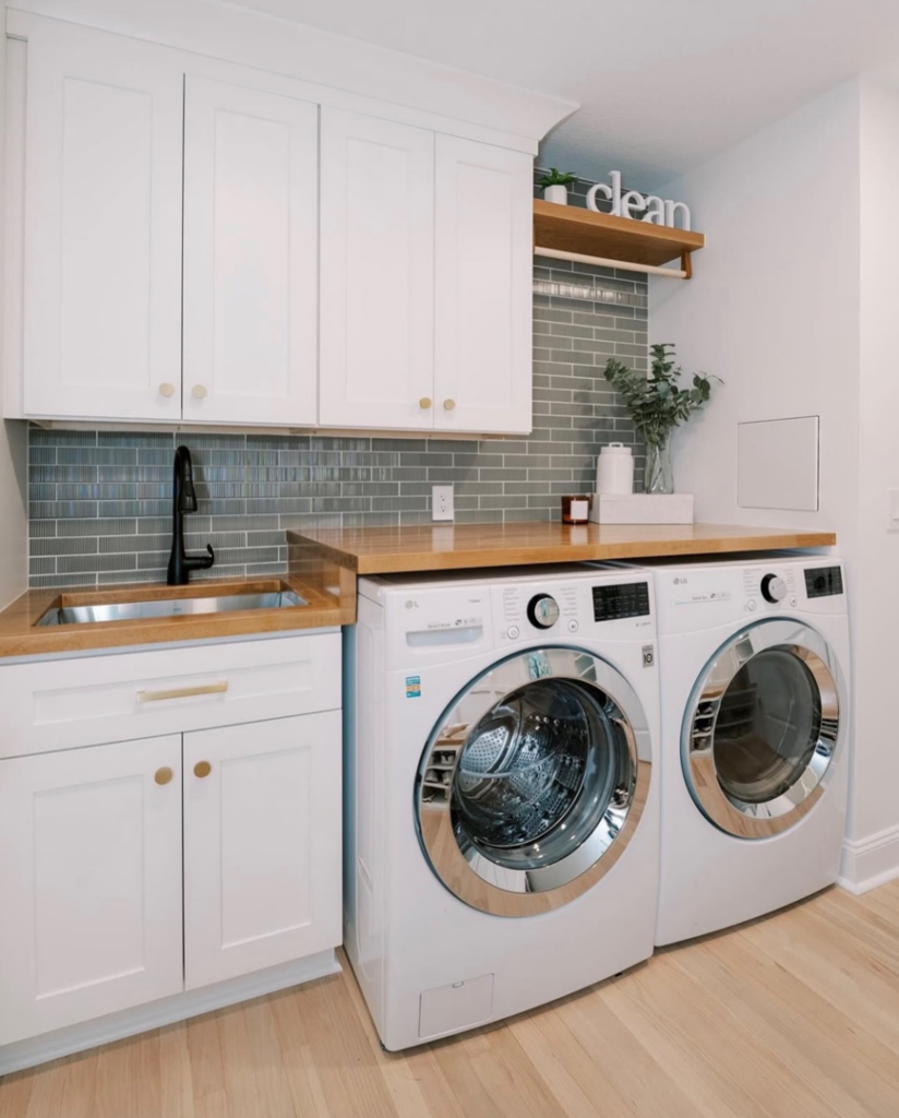 Modern laundry room remodel with white cabinets and wood countertop by Hammer Construction Services in Boca Raton, FL.