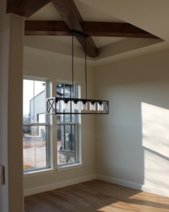 A modern light fixture installed in a home by Coffee Creek Homes in Luther, OK, showcasing quality handyman work.