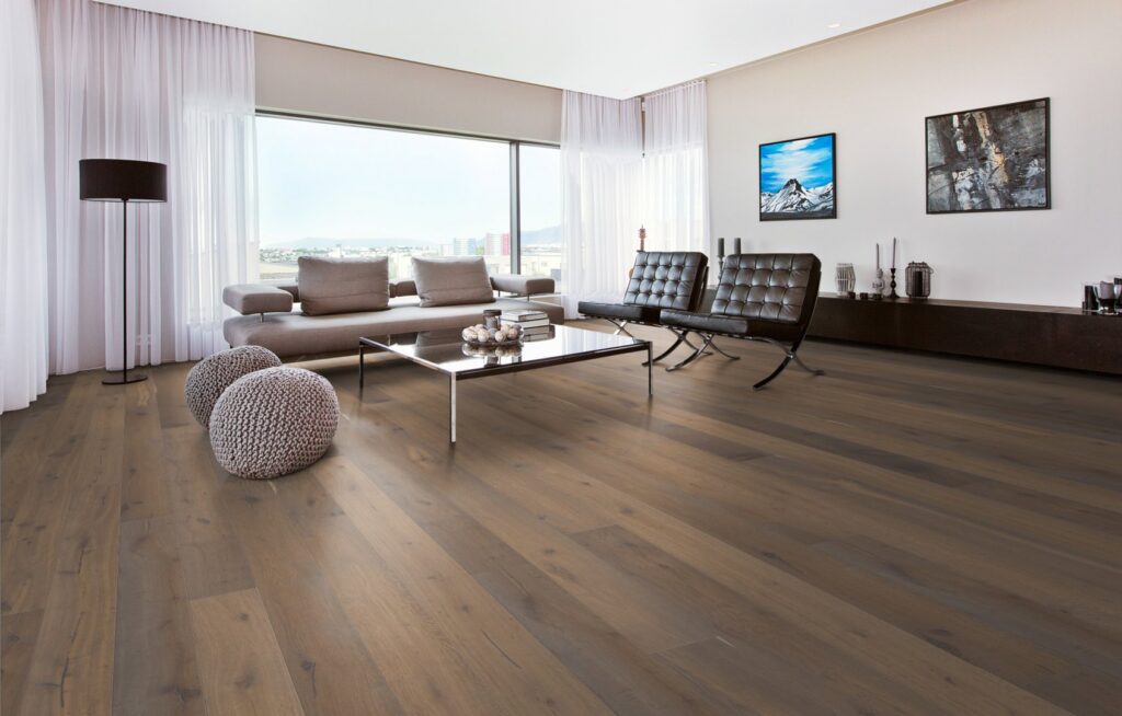 A modern living room showcasing professional hardwood floor installation by Surfaces By Design in Duluth, MN.
