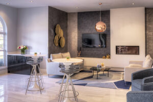 A stylish modern lounge area with a fireplace and bar, showcasing commercial remodeling by Inland Home Remodeling Inc. in Chicago, IL.