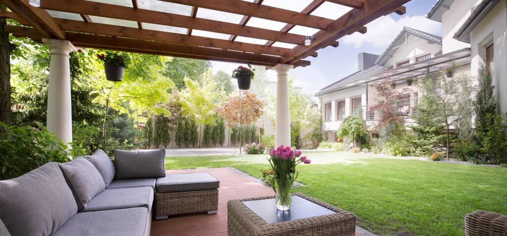 A modern outdoor pergola and patio area designed and built by Tin Star Fencing in Fort Worth, TX