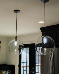 Two modern glass pendant lights professionally installed by Prestige Remodeling Solutions in Antioch, TN