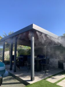 A high-quality mist system installed under a modern pergola with outdoor dining by Mr. Mister in Surprise, AZ