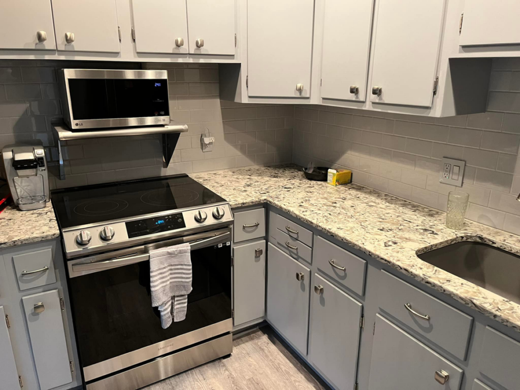 A modern renovated kitchen featuring new cabinets, countertops, and appliances by Lambert's Residential Painting And More LLC in Fort Wayne, IN.
