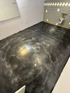 A modern room featuring a stylish grey metallic epoxy floor installed by Donnelly J. LLC Epoxy in St. Charles, MO.