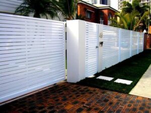 Modern white horizontal slat fence and gate installed by Xclusive Fence And Rails Inc. in Miami, FL.