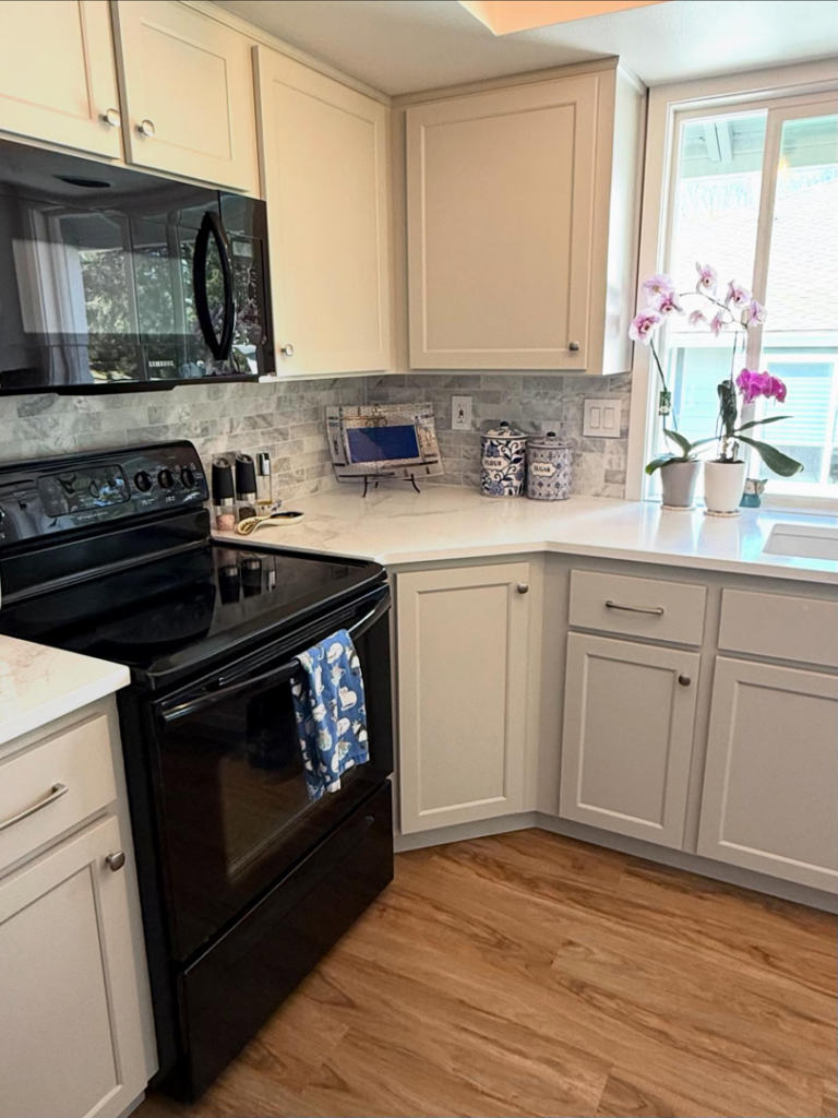 Modern white kitchen cabinets and countertops installed by Cabinet Refinishing Northwest in Beaverton, OR.